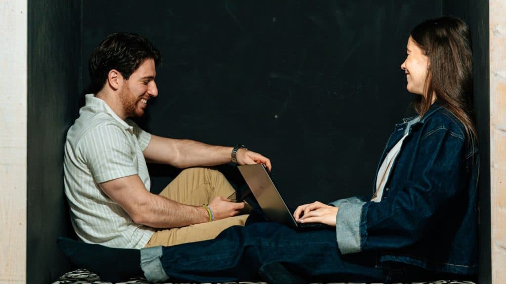 A couple smiling while sitting inside a niche.