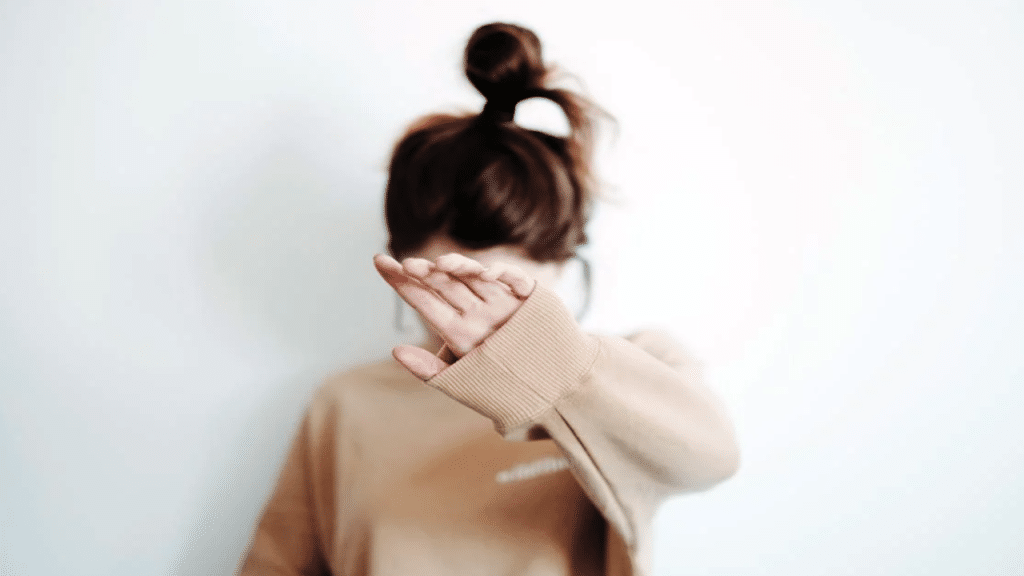 A woman saying no through her hand
