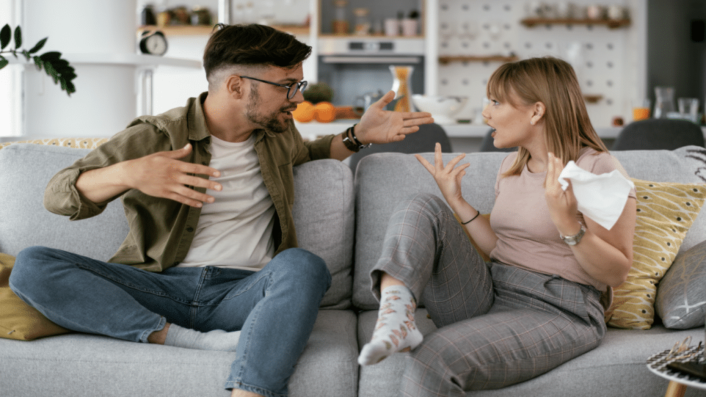 A couple fighting on the couch