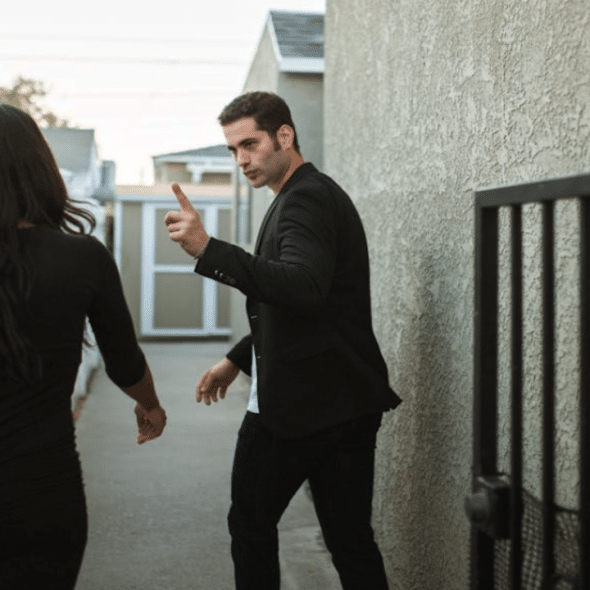 A couple arguing outside their home