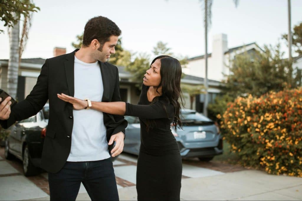 A woman reaching for a man’s phone