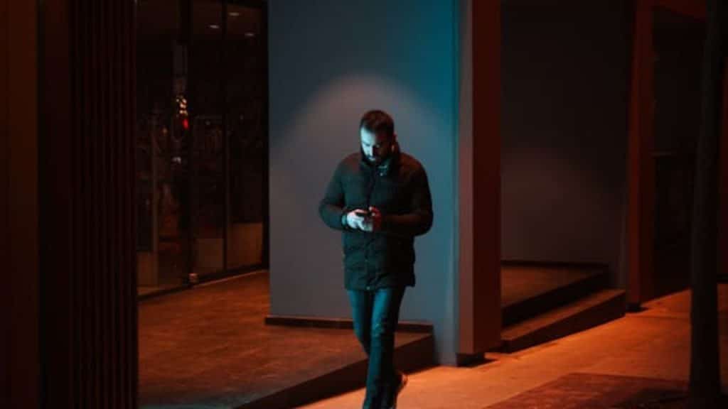 Man walking alone at night, lost in thought