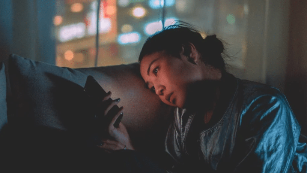 A woman looking sad while on her phone