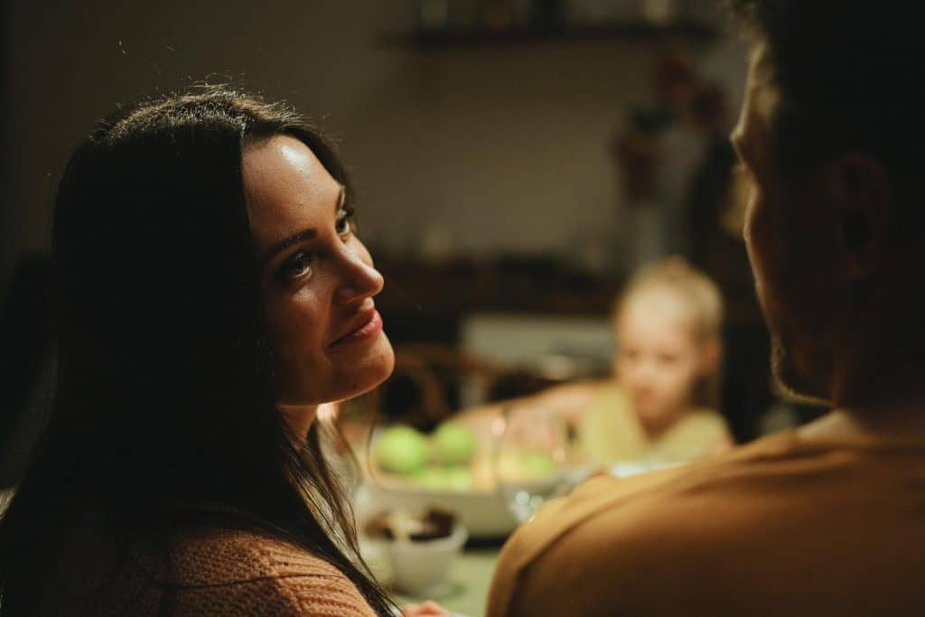 The woman lovingly looks at the man beside her.