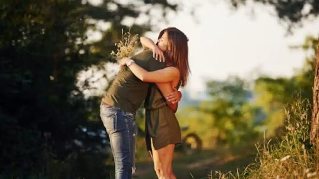 A couple embracing while walking outdoors