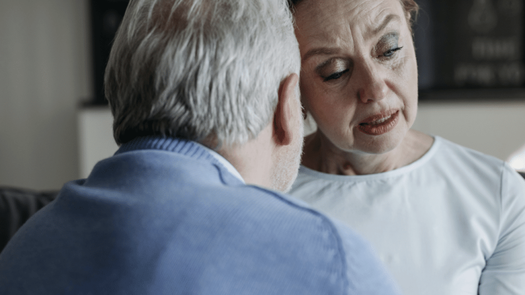 A woman crying as her husband comforts her