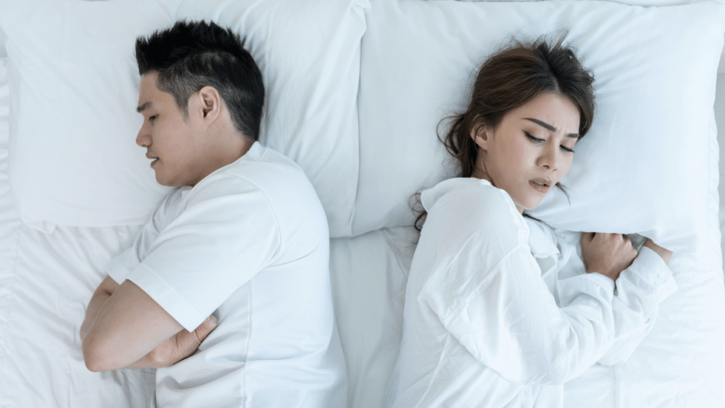 A couple sleeping back to back