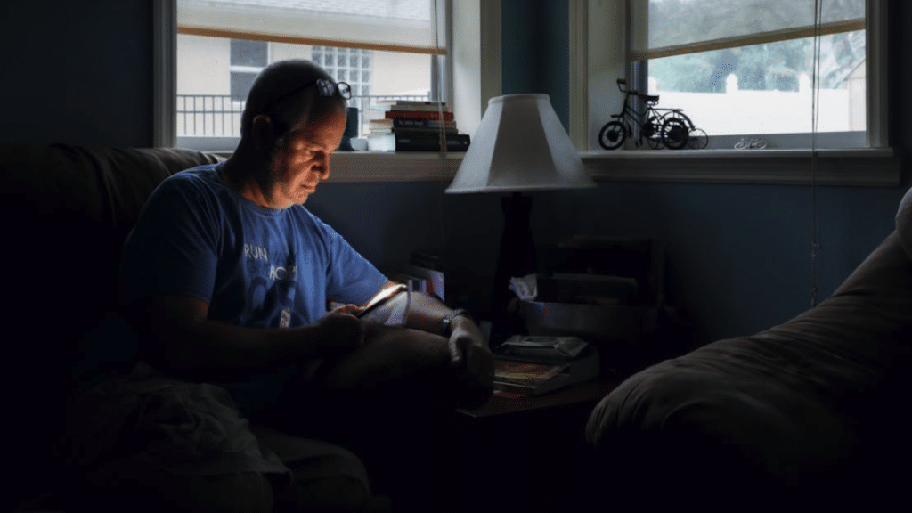 A man using his phone in the dark