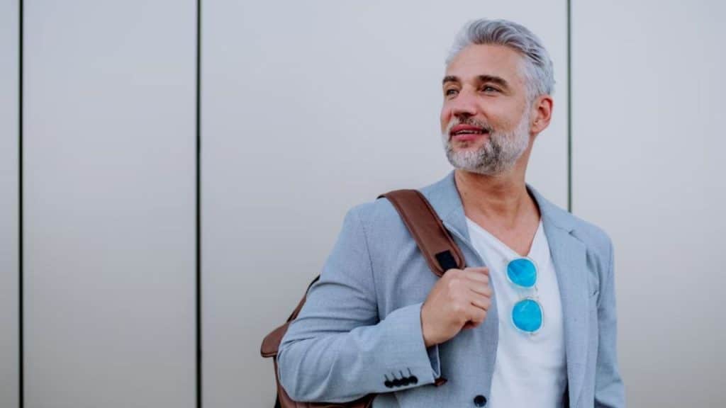 Mature man smiling confidently outdoors