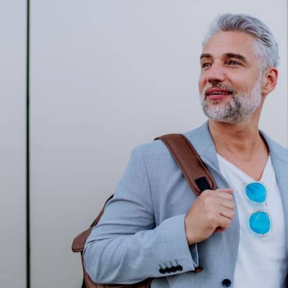 Mature man smiling confidently outdoors