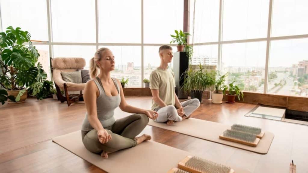 Couple meditating together on yoga mats