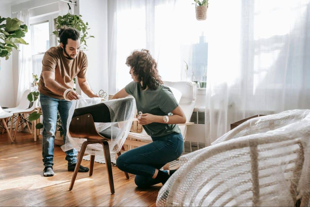 A man and woman helping each other 
