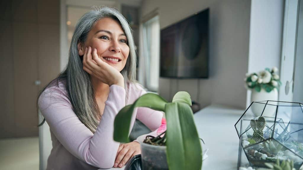 A smiling grey haired mature woman.