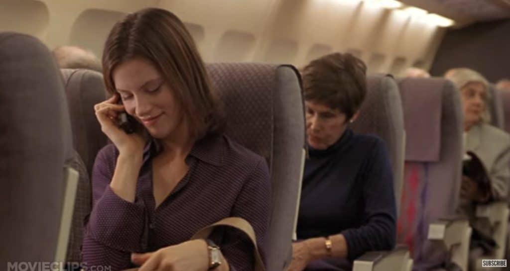 A woman in the plane while talking someone on the phone