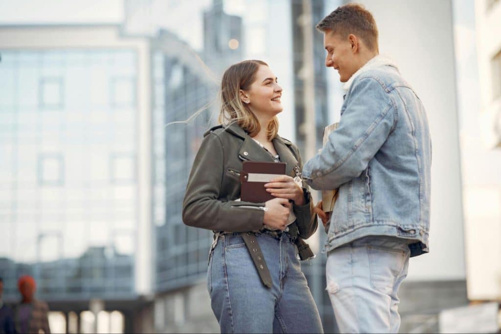 A man and woman talking and standing