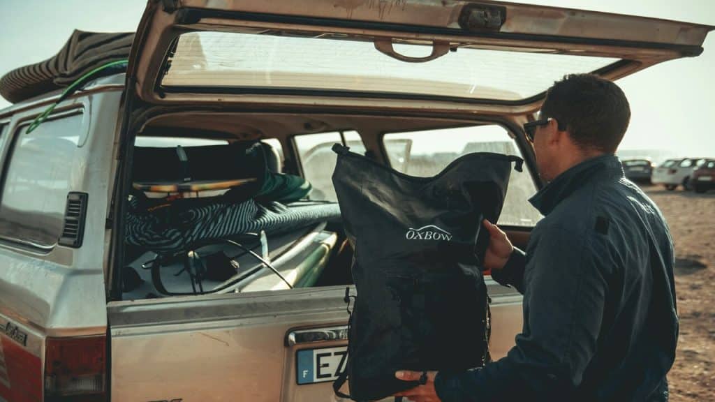 A man putting things in the car