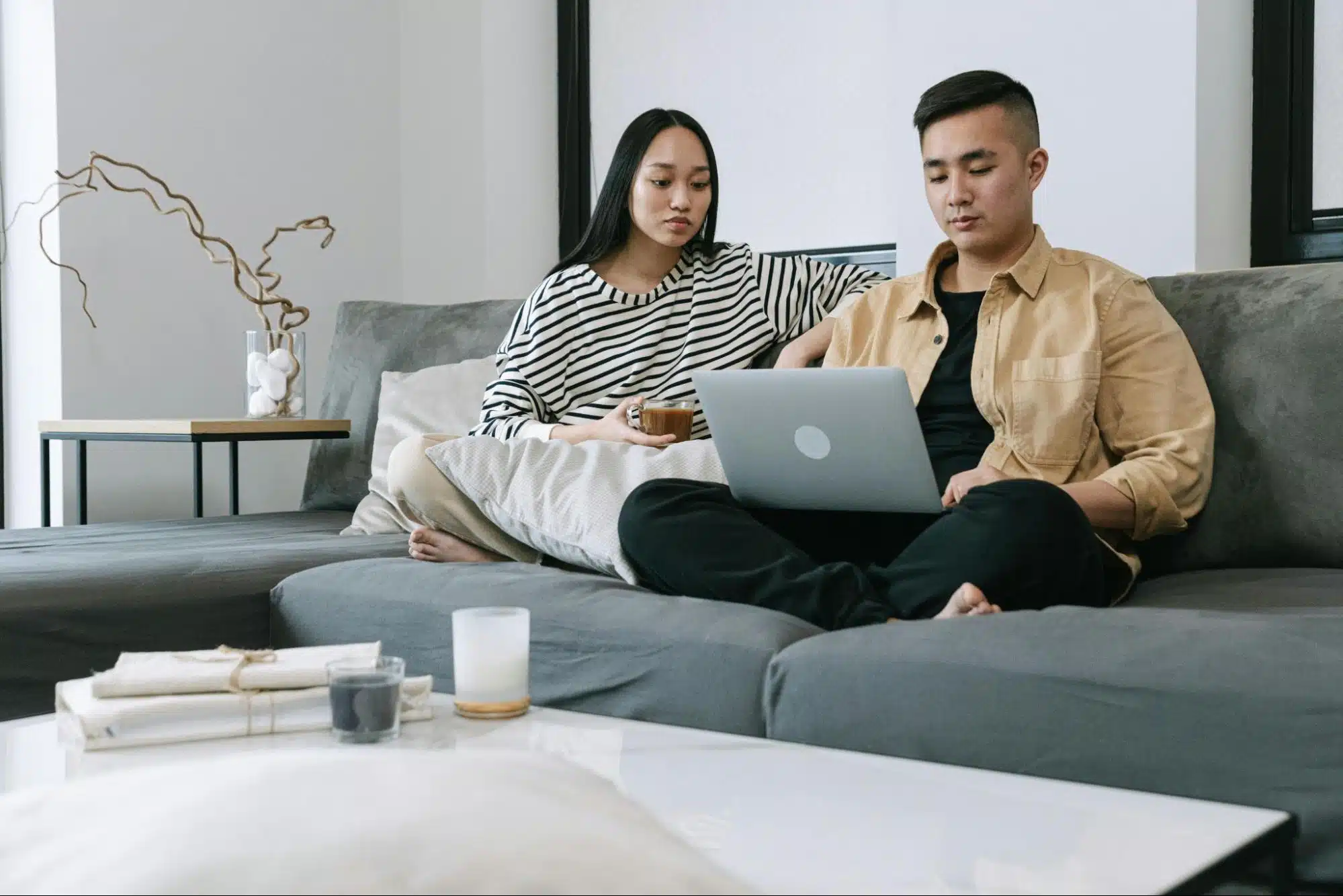A man and woman busy with their laptop