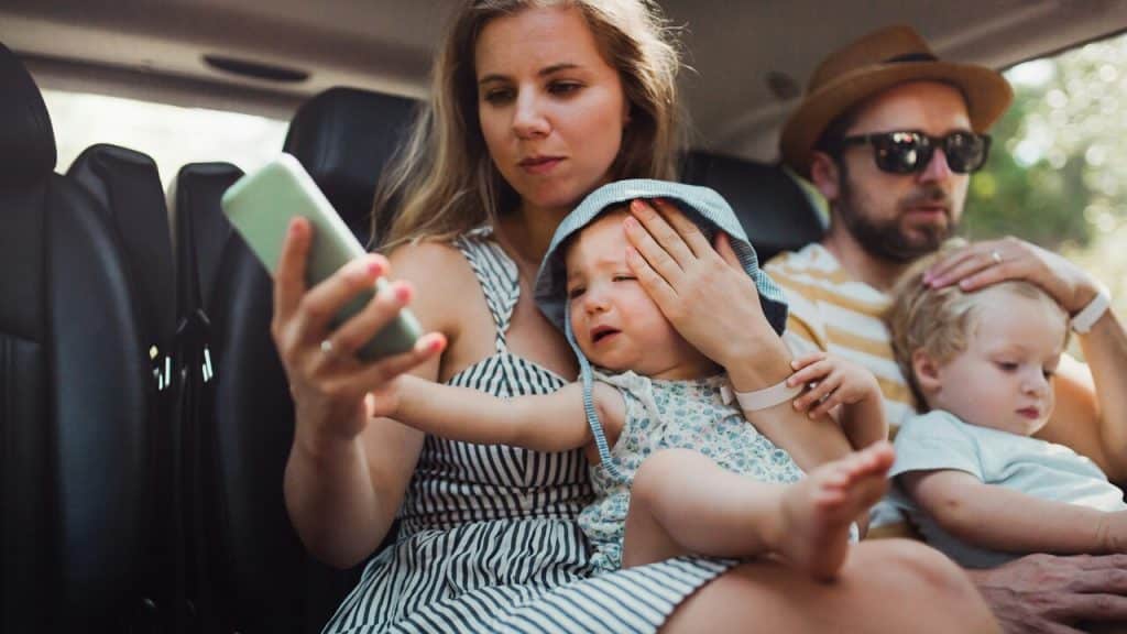 A couple with their kids in the car