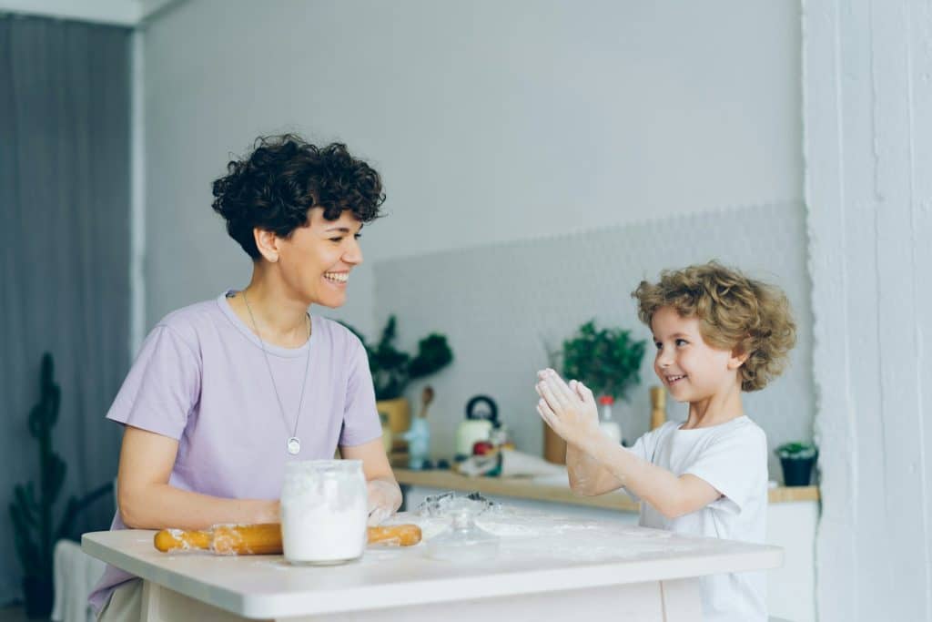 The woman and the kid are sitting at the table.