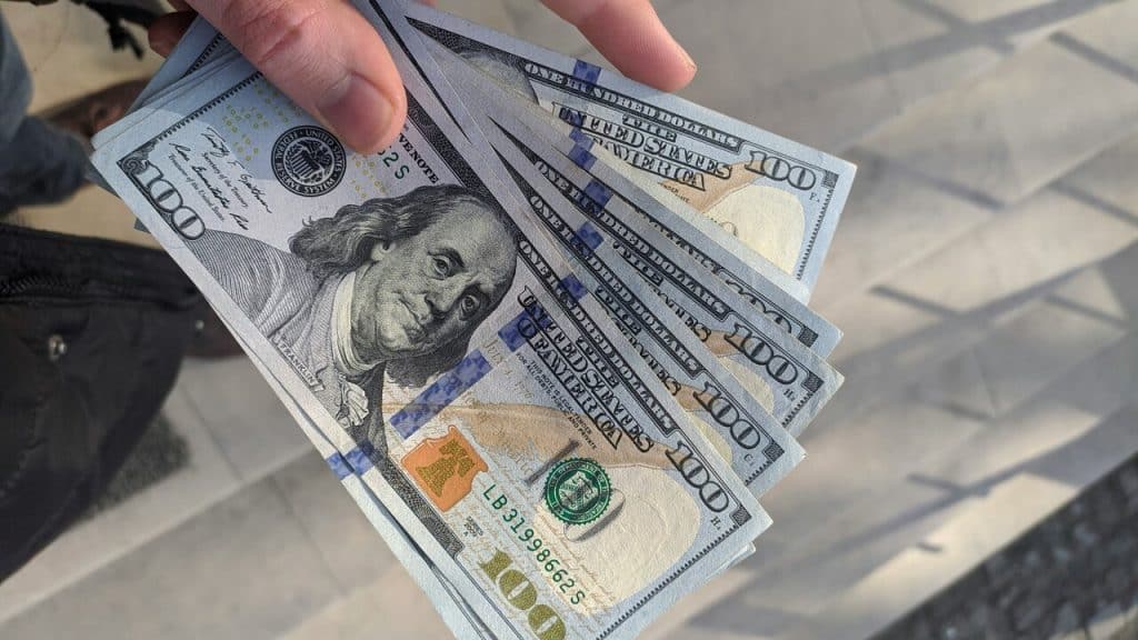 A man holding some dollar bills