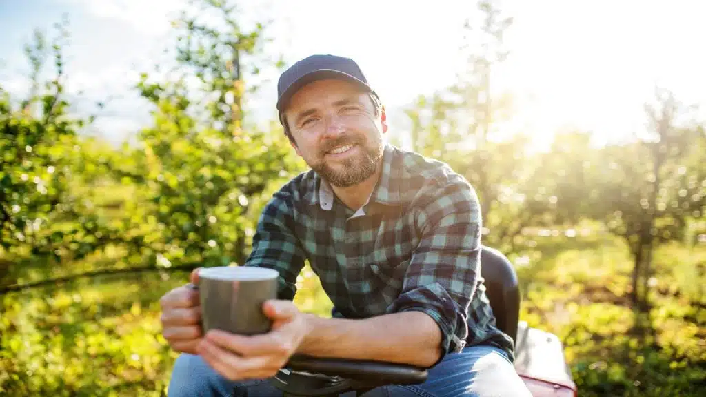 A man drinking coffee outdoors