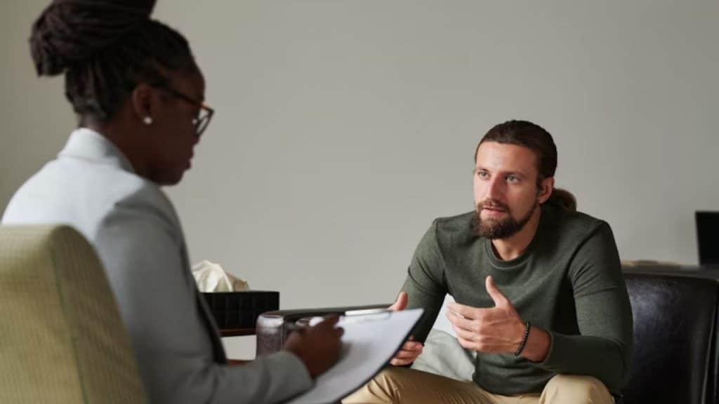 Man speaking with a therapist in an office