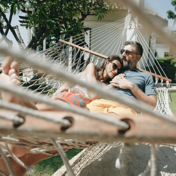 A couple relaxing on a hammock
