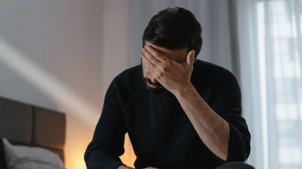 A man looking upset at home