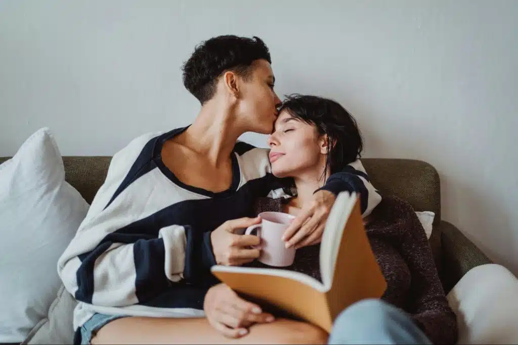 A man kissing a woman’s forehead