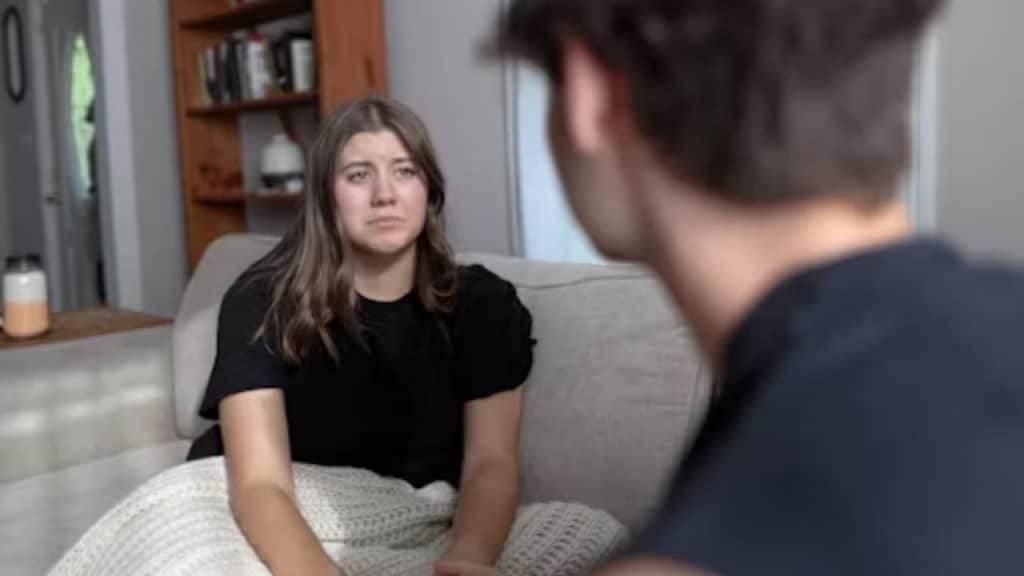 Couple sitting close, woman opening up emotionally