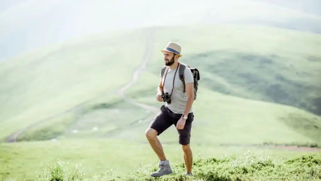 Man hiking alone in nature, smiling contently