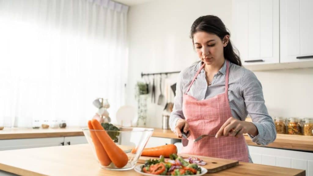 Woman performing household tasks out of routine rather than affection