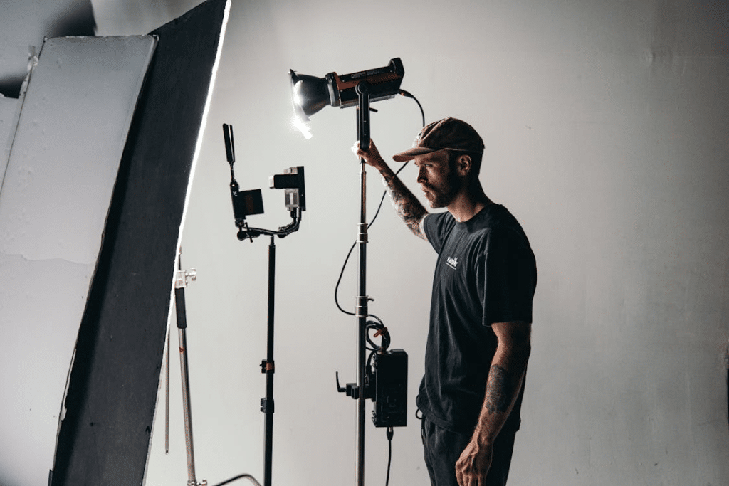 Man in Black Crew Neck T-shirt Standing Near Black Microphone