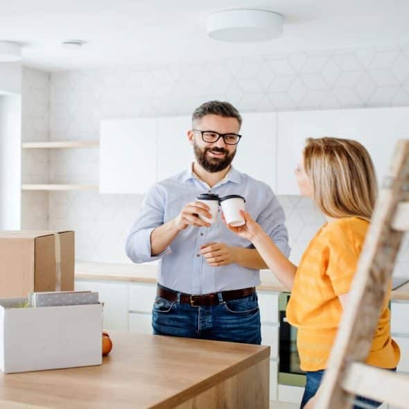 A couple having coffee while moving into a new home