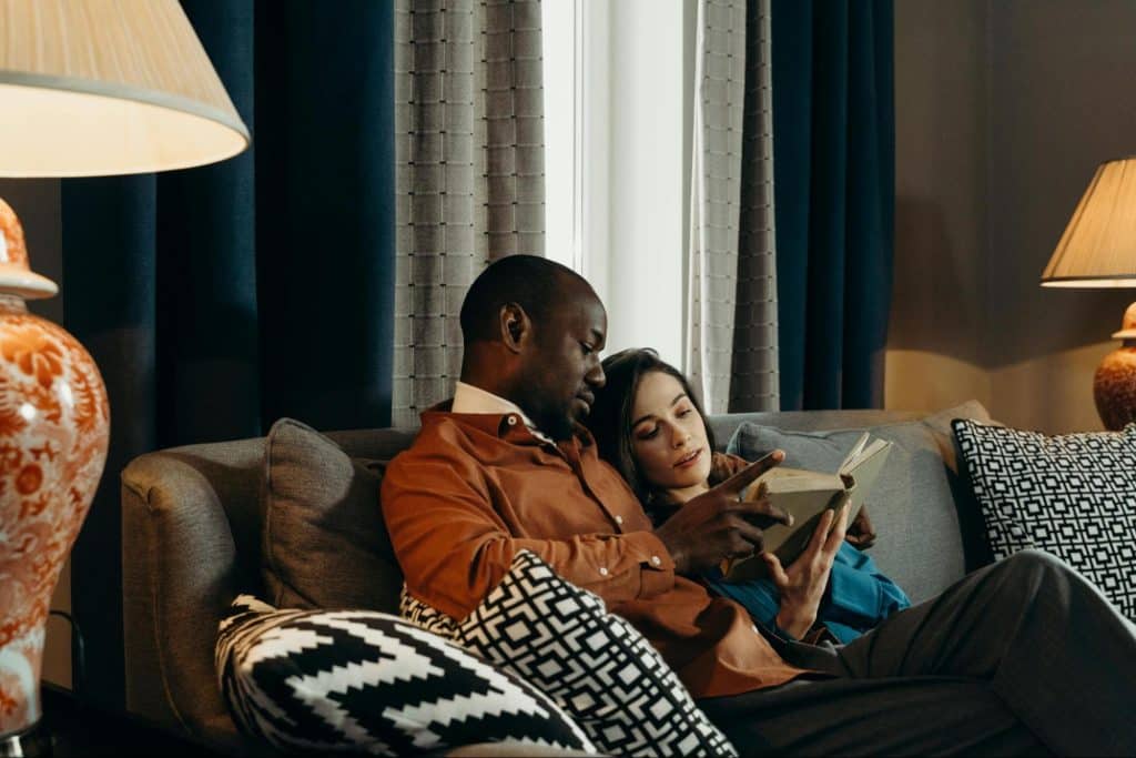 A man and woman reading a book