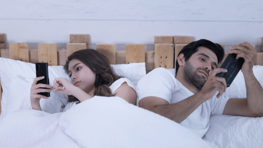 A couple ignoring each other for their phones