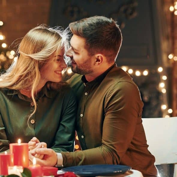 A couple having a romantic candlelight dinner.