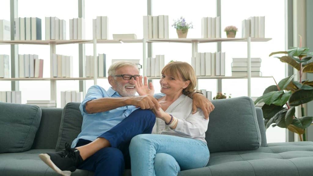 A couple laughing together in the living room