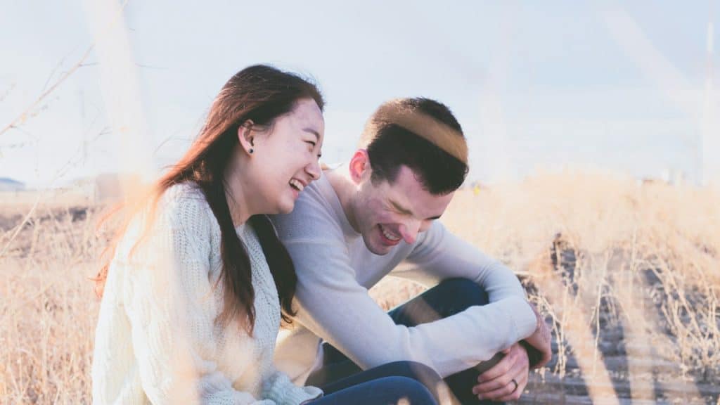 A couple laughing together.