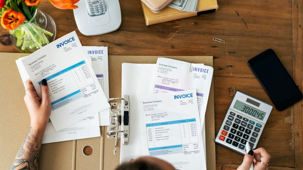 A woman looking through monthly bills.