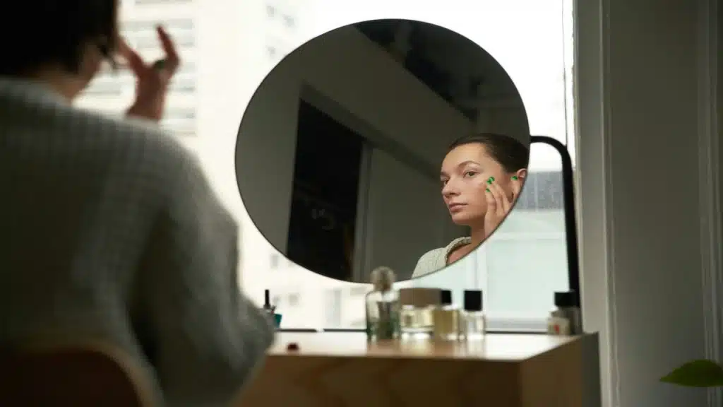 A woman looking at herself in the mirror 