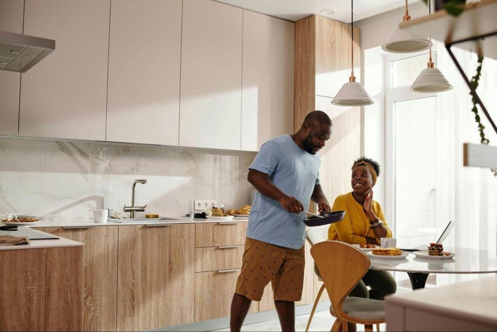 A man cooking for woman