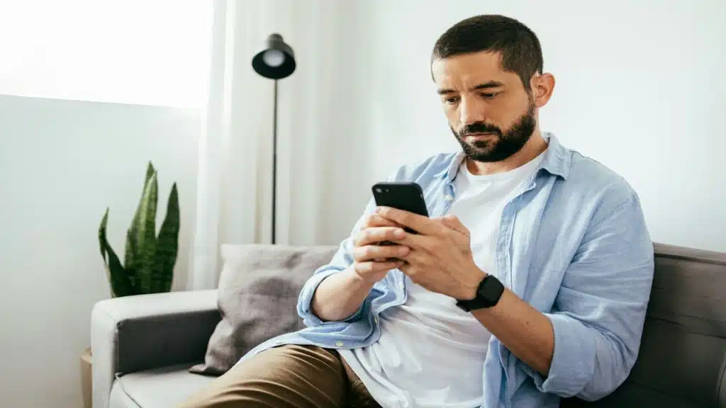 A man looking sad while on the phone