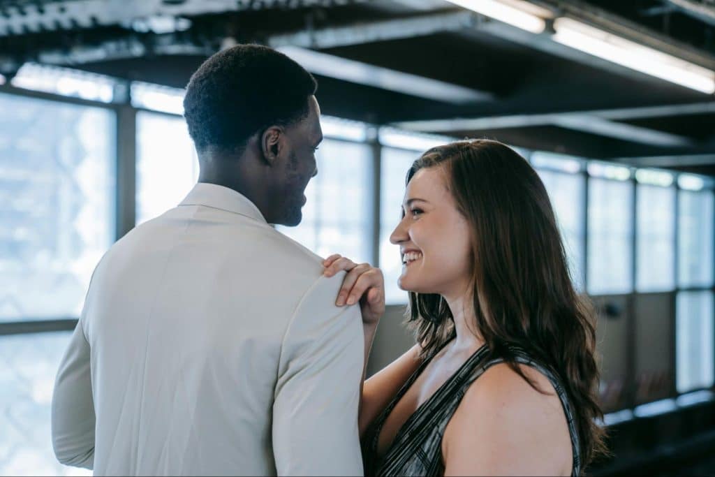 A woman holding the shoulder of a man