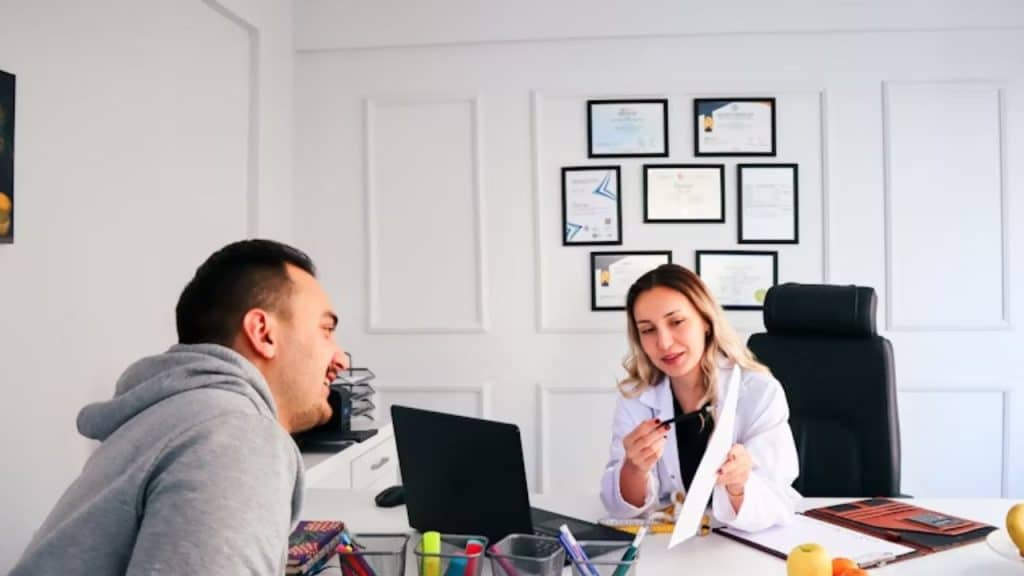 Man at a doctor’s office talking with a physician