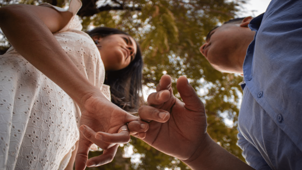 A couple doing the pinky swear 