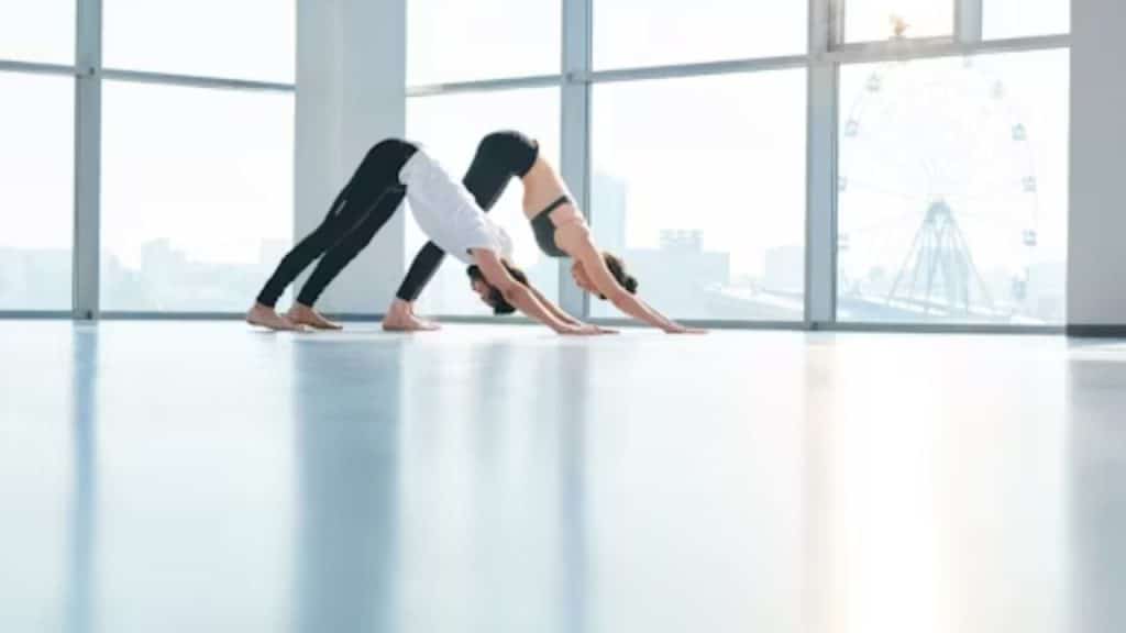A man and a woman stretching in a calm environment