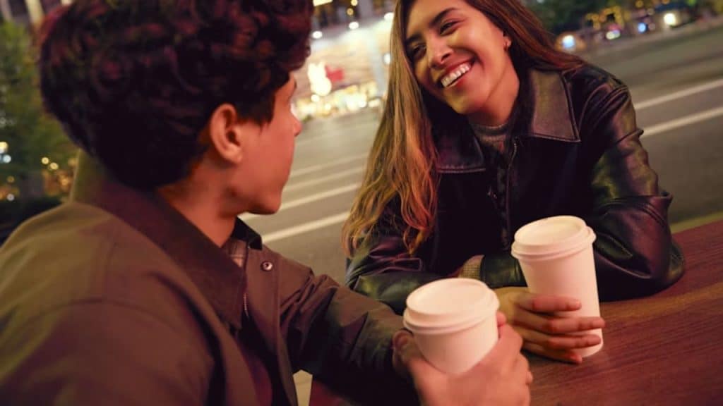 Couple laughing awkwardly during a tense conversation