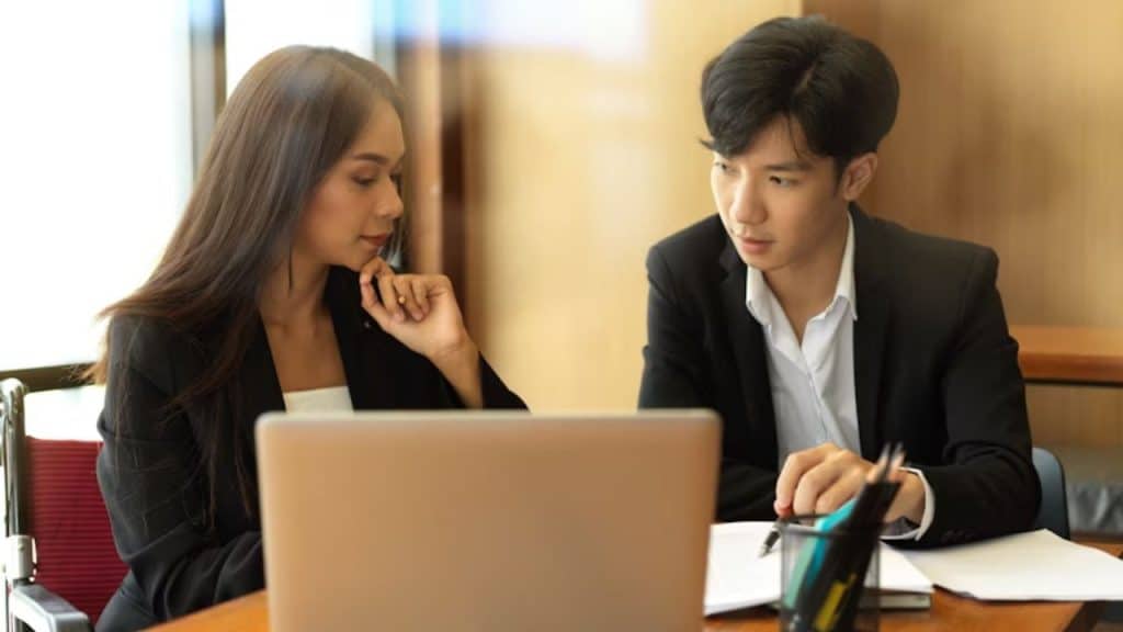 Couple having a tense conversation while reviewing bills