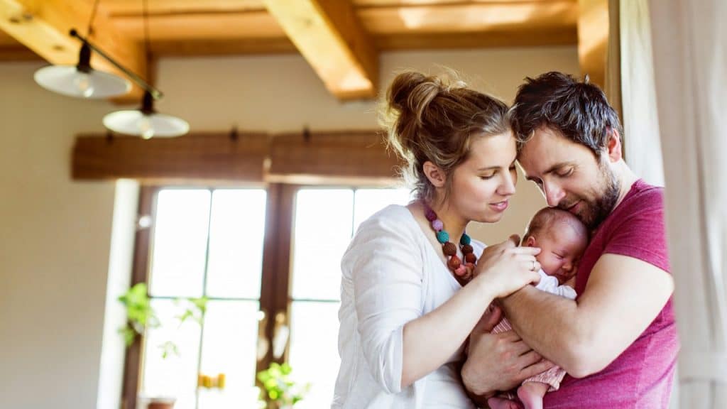 A couple looking at their baby. 